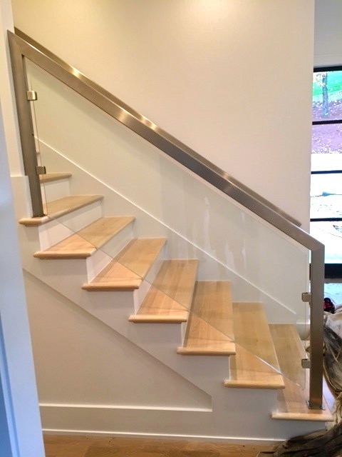 Frameless glass stair railing with handrail