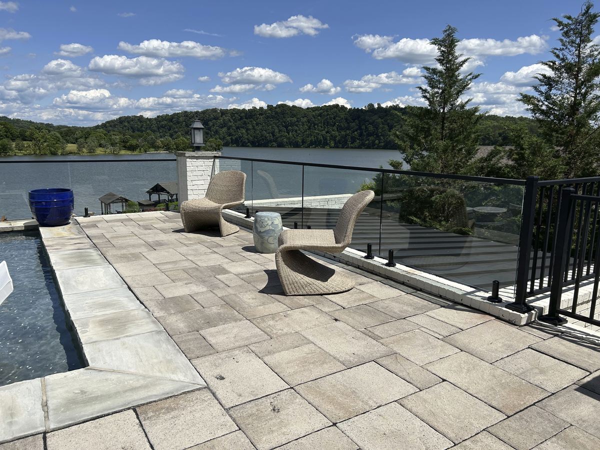 Frameless glass railing on a lakeside patio