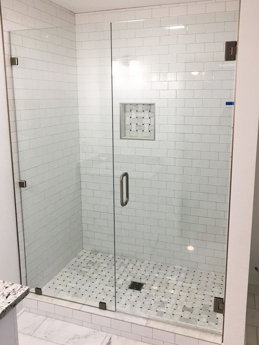 Frameless glass shower enclosure