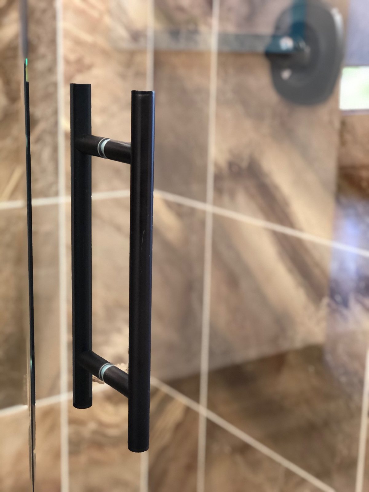 Ladder shower door hardware installed by Clinton Glass